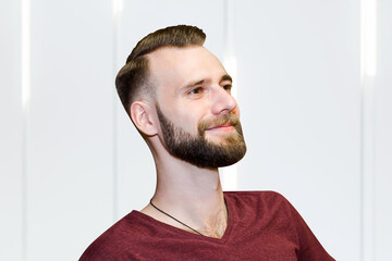 sport young bearded guy with a modern trendy fade haircut for barbershop, side