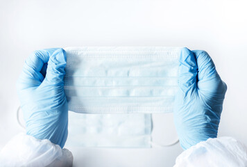 Doctor's hands with a medical mask to protect against infection. Antiviral medical mask for...