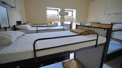 Empty room for a cheap hostel with bunk beds.