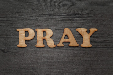 Fototapeta premium Pray words text, wooden alphabet lettering