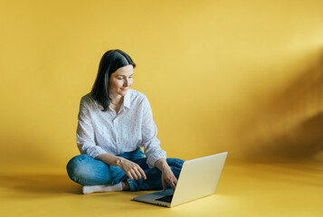 
Use of gadgets by the millennium generation. 
A woman works on a laptop computer. Copy space for text.