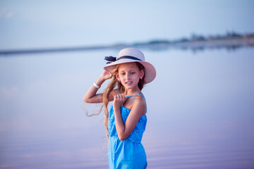 travels. beautiful girl on the lake. child on the beach. beautiful sunset. portrait of a child. long haired girl. relaxation and relaxation