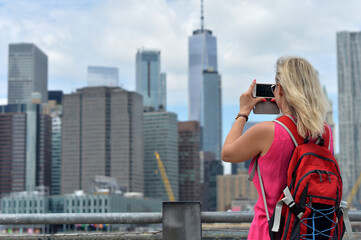 Woman taking picture New York city skyline