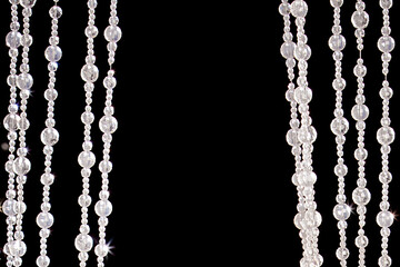 crystal bead curtain on black background copy space