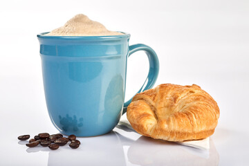Coffee cup with croissant on white background