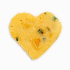 Freshly baked pancake in shape of heart close up.