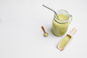 Matcha latte with coconut milk in jar glass