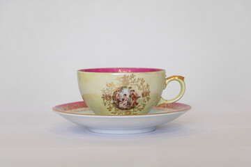 Painted porcelain Cup and saucer on a white background