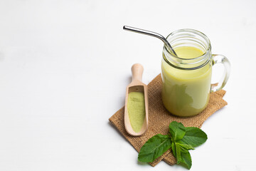 Matcha latte with coconut milk in jar glass