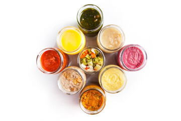Nutrition concept - Healthy food, Diet, Detox, Clean Eating or Vegetarian concept. A set of nutritious food on small glass jars against white background. Set of delicious food in glass jars. Top view