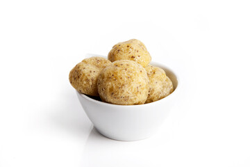 Healthy homemade cheese buns with chia on a white plate over white background.