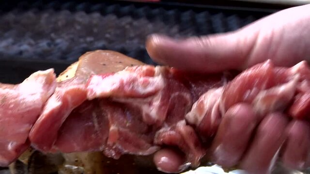 BBG picnic. Barbecue meat preparation for roasting on burning fire in brazier grill. 