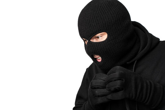 Portrait of masked thief isolated over white studio wall