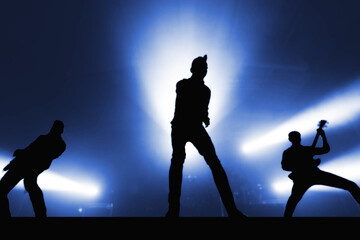 Silhouettes of cool rock band musicians on stage. outlines of popular musicians for a music festival banner