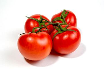 a sprig of red tomatoes is isolated on a white background