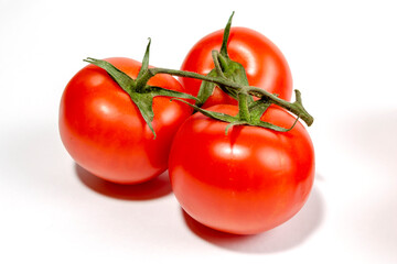 a sprig of red tomatoes is isolated on a white background