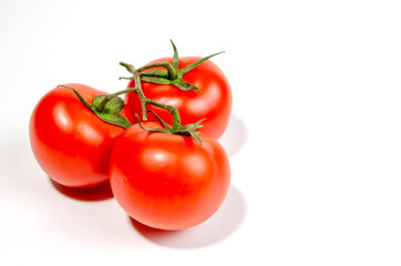 a sprig of red tomatoes is isolated on a white background