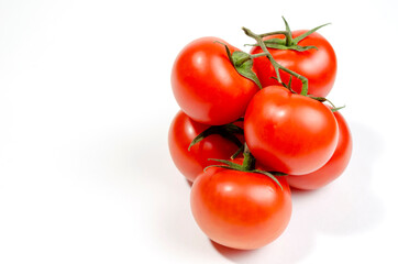 a sprig of red tomatoes is isolated on a white background
