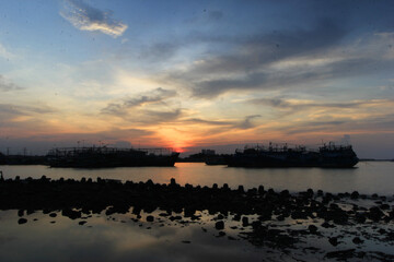 BEAUTIFUL SUNSET IN MUARA ANGKE BEACH, NORTH JAKARTA, INDONESIA