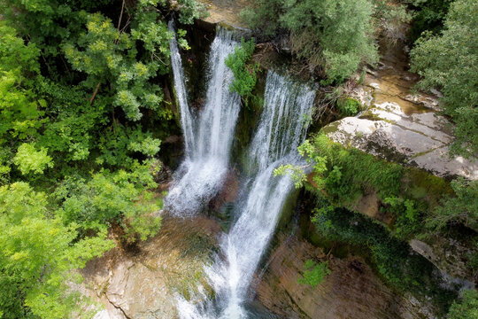 Aerial view of an Idyllic rain forest waterfall, stream flowing in the lush green forest. High quality image.