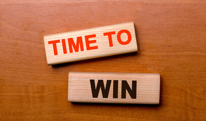 Time to win is written on village blocks on a wooden table.