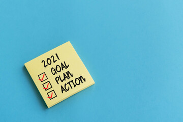 2021 goal, plan, action checklist text on adhesive note blue background