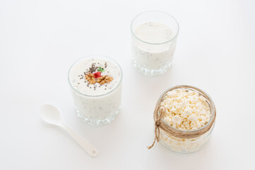 Yogurt with nuts and chia seeds. Homemade cheese in a glass jar.