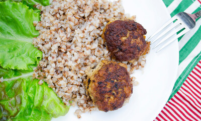 Cutlets with buckwheat porridge and salad. Healthy eating concept. Macro photo. Top view and side view. Erupny plan of the dish.
