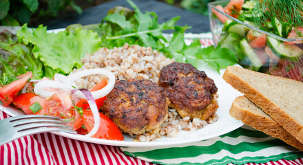 Cutlets with buckwheat porridge and salad. Healthy eating concept. Macro photo. Top view and side view. Erupny plan of the dish.