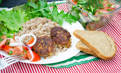 Cutlets with buckwheat porridge and salad. Healthy eating concept. Macro photo. Top view and side view. Erupny plan of the dish.