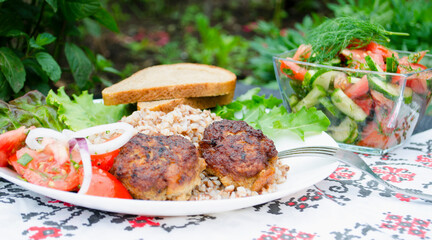 Cutlets with buckwheat porridge and salad. Healthy eating concept. Macro photo. Top view and side view. Erupny plan of the dish.