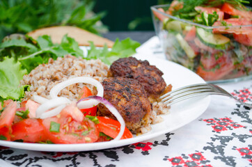 Cutlets with buckwheat porridge and salad. Healthy eating concept. Macro photo. Top view and side view. Erupny plan of the dish.