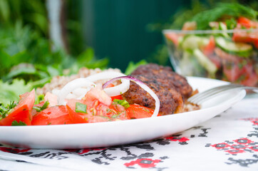 Cutlets with buckwheat porridge and salad. Healthy eating concept. Macro photo. Top view and side view. Erupny plan of the dish.