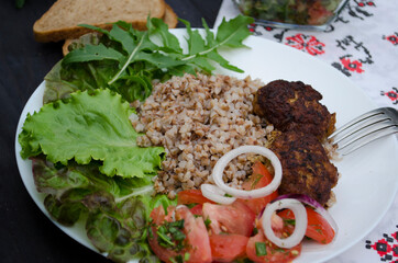 Cutlets with buckwheat porridge and salad. Healthy eating concept. Macro photo. Top view and side view. Erupny plan of the dish.