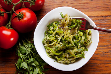 Nutrition concept - Healthy food, Diet, Detox, Clean Eating or Vegetarian concept. Healthy pasta with sauce, basil, fresh tomatoes over rustic wooden background