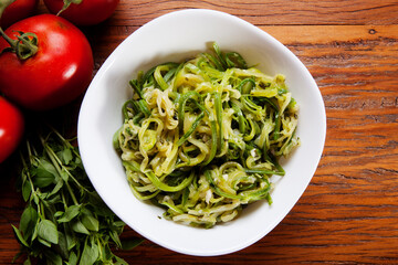 Nutrition concept - Healthy food, Diet, Detox, Clean Eating or Vegetarian concept. Healthy pasta with sauce, basil, fresh tomatoes over rustic wooden background