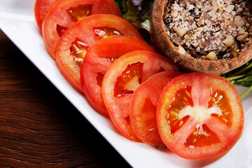 Nutrition concept - Healthy food, Diet, Detox, Clean Eating or Vegetarian concept. A delicious quiche with salads and tomatoes slices in white plate over wooden background.