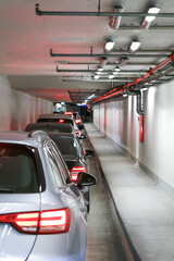 Fire extinguishing system in underground Parking. Traffic jam at entrance. Tunnel full of cars.