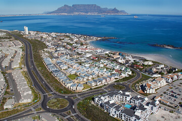 Cape Town, Western Cape / South Africa - 07/26/2011: Aerial photo of Big Bay beachfront and apartments with Table Mountain in the background