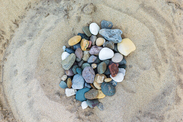 Fototapeta na wymiar heart shaped stones on the sand