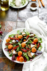 Salad with fried cheese. Baked carrots, beets, salad mix, arugula, eggplant, cherry tomatoes, mozzarella, brie cheese, capers, olive oil