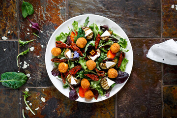 Salad with fried cheese. Baked carrots, beets, salad mix, arugula, eggplant, cherry tomatoes, mozzarella, brie cheese, capers, olive oil