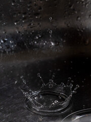 Drop of water falling on a sink