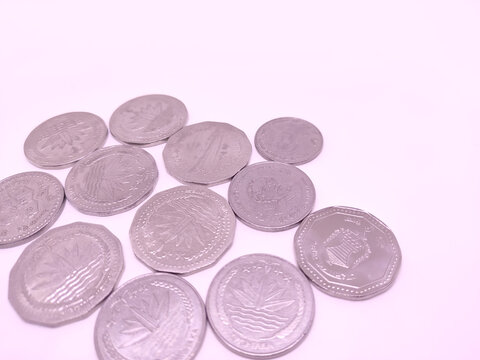 Coins of Bangladeshi currency over white background.