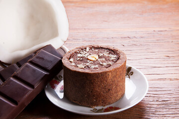 Nutrition concept -Healthy small sweet quiche pie over wooden background. Healthy food, Diet, Detox, Clean Eating or Vegetarian concept. Homemade delicious baked muffin with chocolate and coconut.