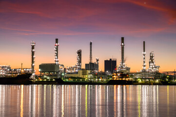 Oil refinery plant from industry, petrochemical oil and gas refinery and pipeline industry with sunrise sky background.