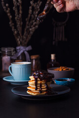 Cooking delicious pancakes with a blueberry jam