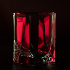 Cognac glass in ruby light with white highlights.