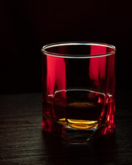 A glass of cognac. A glass of cognac in ruby light.