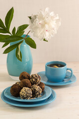 A portion of homemade energy balls and a Cup of tea on the table. Delicious, healthy dessert for Breakfast. Lifestyle